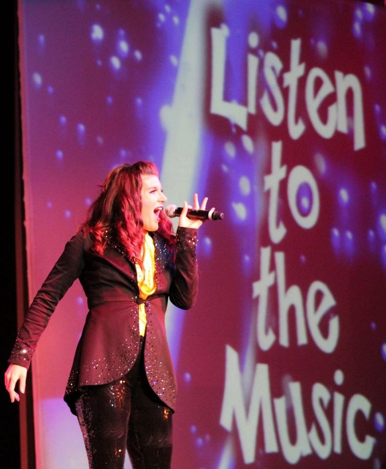 Patricia Butterfield singing on stage